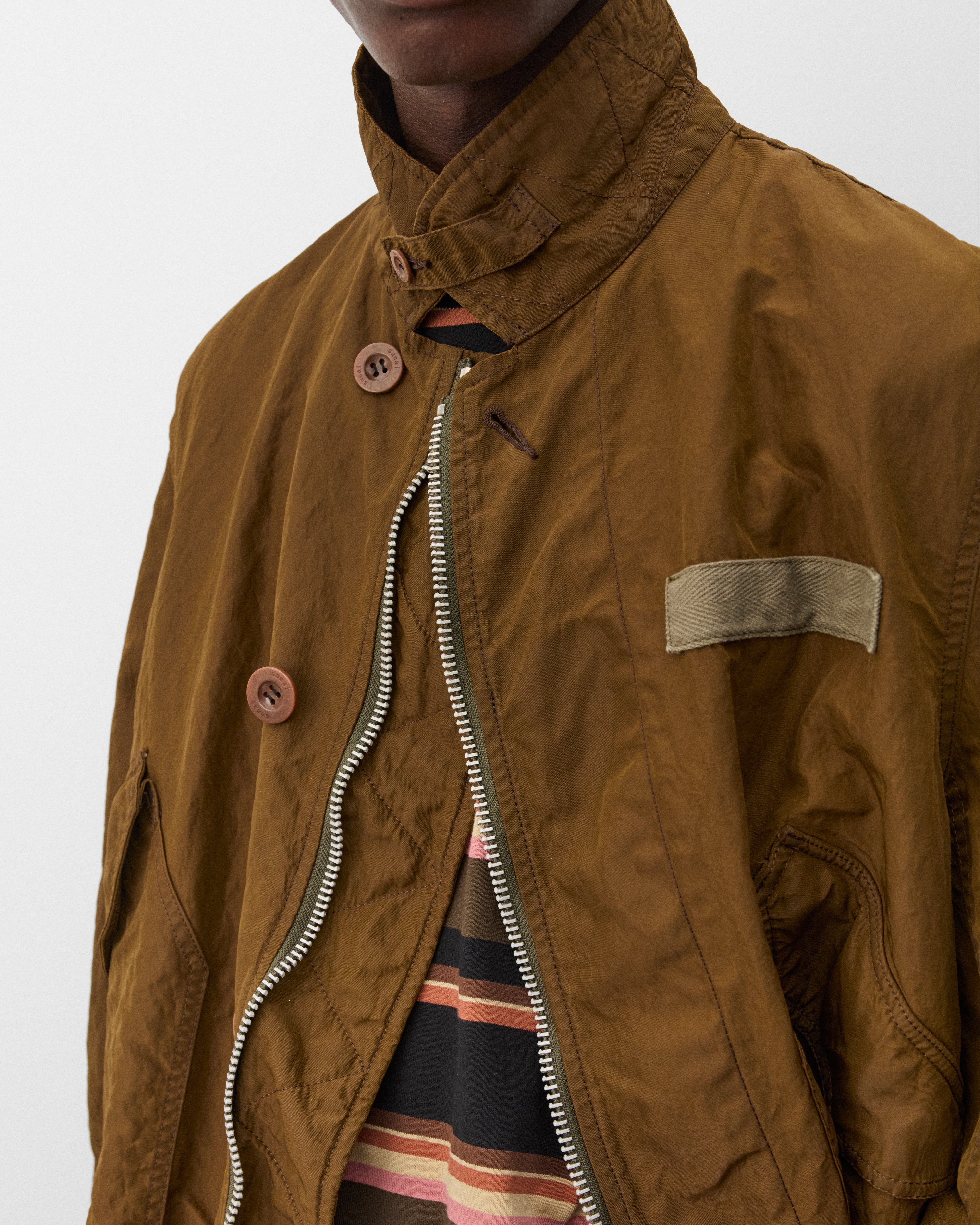 Sacai: Men's Treated Nylon Twill Coat (Green) | Dover Street